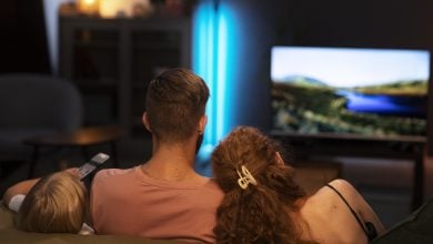 back view family watching tv