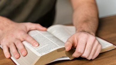 man reading from bible table 23 2148822678