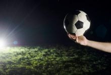 crop hand with soccer ball 23 2147820702